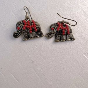 Silver elephant earrings with red beading.